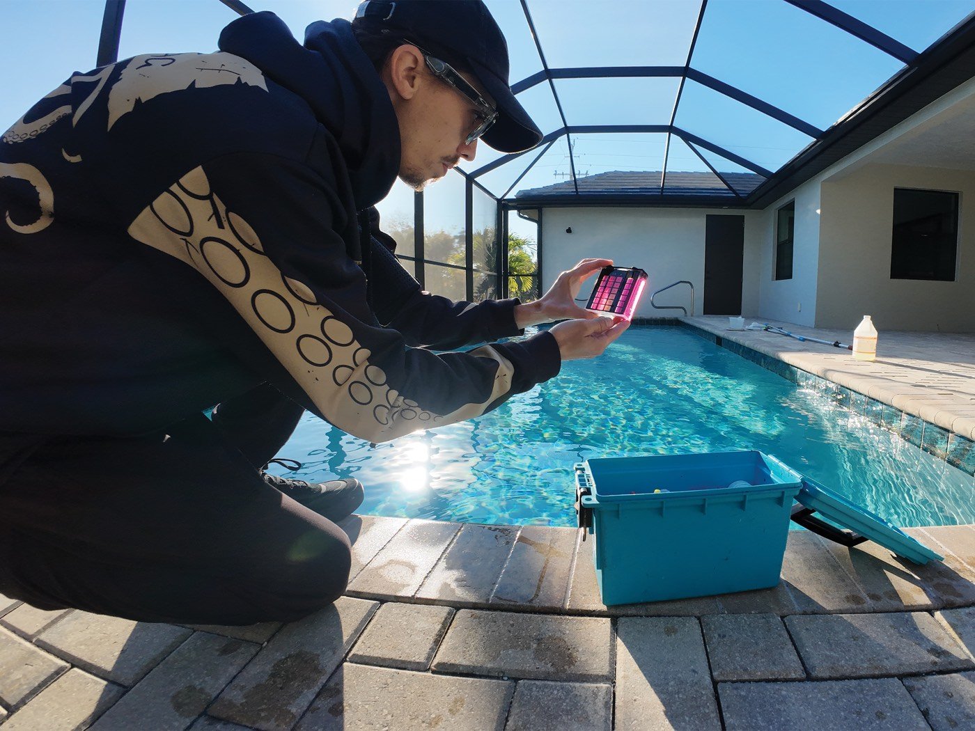 Sparkling screened pool maintained by Black Flag Pools